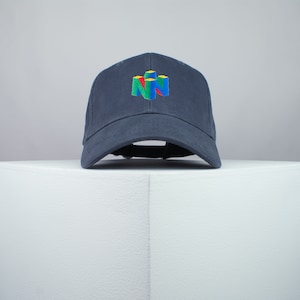 May include: A dark blue baseball cap with a white, red, green, and yellow Nintendo logo embroidered on the front.