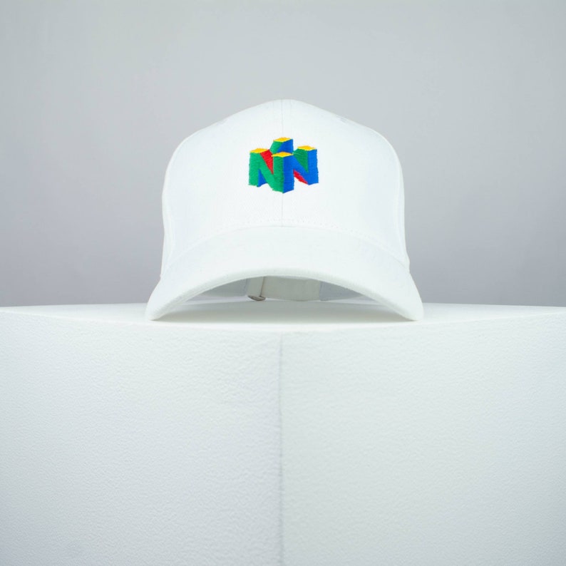 May include: White baseball cap with a colorful Nintendo logo embroidered on the front.