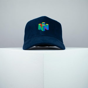 May include: A navy blue baseball cap with a colorful Nintendo 64 logo embroidered on the front.