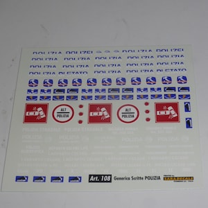 May include: A sheet of police-themed decals with various designs and text. The decals include red and white road signs, blue and white vehicle graphics, and the word "POLIZIA" repeated across the top. The text "Art. 108 Generica Scritte POLIZIA" is also visible.