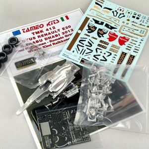 May include: A model kit of a Lotus Renault E20 race car. The kit includes various parts, decals, and instructions. The kit's packaging includes the text "TAMEO KITS TMK 412 US RENAULT E20 ABU DHABI 2012".