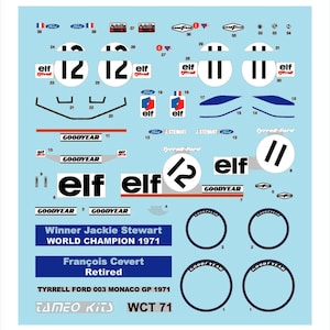 Puede incluir: Una hoja de calcomanías de carreras con los logotipos "elf" y "Goodyear", números de carrera y texto. El texto incluye "Winner Jackie Stewart WORLD CHAMPION 1971" y "François Cevert Retired". Las calcomanías están sobre un fondo azul claro.