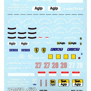 Puede incluir: Hoja de calcomanías para un modelo Ferrari F1-89. Incluye logotipos de Agip, Fiat y Goodyear, junto con los números de carrera 27 y 28. También presenta texto para los Grandes Premios de Hungría y Brasil.