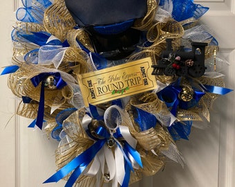 May include: A festive wreath with blue, gold, and white mesh, adorned with blue ribbons, bells, and a miniature train. A conductor's hat and a ticket that reads "The Polar Express Round Trip" are also included. This holiday decoration is perfect for Christmas.