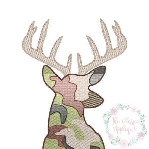 May include: Embroidered design of a camouflage deer head with antlers, with the name "Logan" written below in orange thread.
