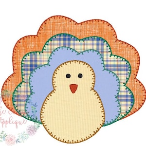 May include: A patchwork turkey applique with a brown body, blue feathers, and orange and plaid accents.