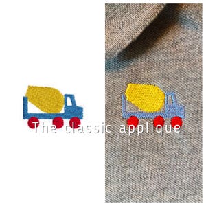 Puede incluir: Una aplicación bordada de un camión mezclador de cemento azul y amarillo con ruedas rojas. El texto "The classic applique" está debajo del camión.