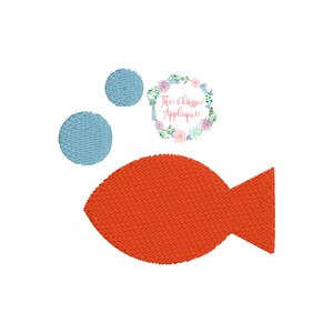 May include: An applique design of a red fish with two blue circles above it. The design is surrounded by a floral wreath with the text "The Classic Applique".