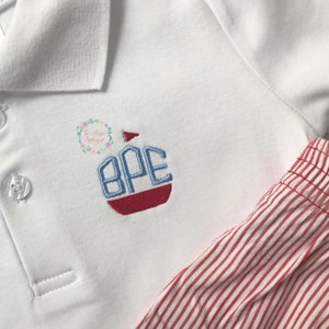 May include: White polo shirt with a red, white, and blue embroidered boat monogram with the letters "BPE".