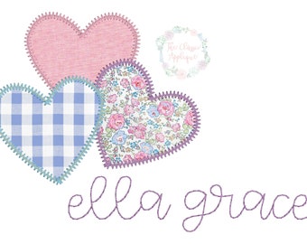 May include: Three embroidered hearts in a layered design. The top heart is pink, the middle heart is blue and white gingham, and the bottom heart is white with a floral pattern. The name "ella grace" is embroidered in purple below the hearts.