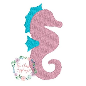 May include: A pink seahorse embroidery design with turquoise accents. The seahorse is the primary focus, with a detailed stitched texture. The design includes a floral wreath with the text "The Class Applique".