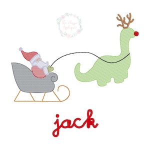 May include: An embroidered design of Santa Claus in a sleigh, pulled by a green dinosaur with antlers and a red nose. The word "jack" is written in red script below the image. A floral wreath is in the upper left corner.