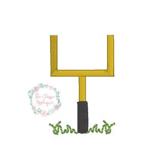 May include: A gold football goal post with a black post and green grass at the base.