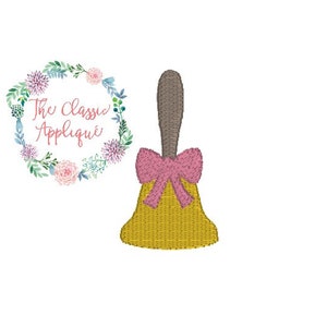 May include: A gold school bell with a pink bow and a brown handle. The bell is a popular classroom decoration.