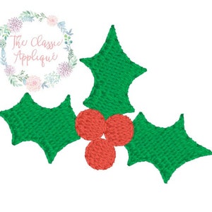 May include: A green holly leaf with three red berries. The holly leaf is a traditional Christmas decoration.