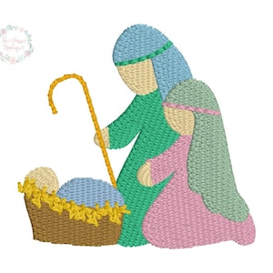 May include: Embroidered design of the nativity scene with Joseph, Mary, and baby Jesus in a manger. Joseph is holding a staff and Mary is wearing a blue robe. The baby is wrapped in a blue blanket and lying in a brown manger.