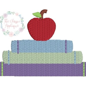 May include: A stack of three books with a red apple on top. The books are purple, green, and blue. The apple has a green stem and leaf.