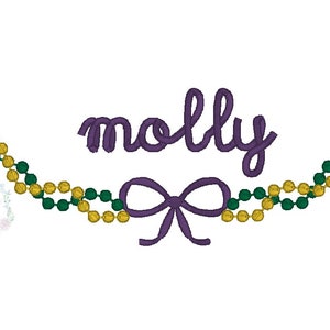 May include: Purple embroidered name "molly" with a purple bow and a green and gold beaded garland.