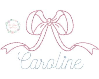 May include: A pink embroidered bow with tails, with the name "Caroline" embroidered in blue below.