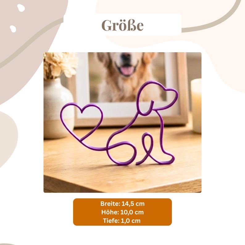 May include: A purple wire dog sculpture with a heart-shaped tail. The sculpture is on a wooden surface. The image also includes a framed photo of a dog, a vase with flowers, and a lit candle. The sculpture is 5.7 inches wide, 3.9 inches high, and 0.4 inches deep.