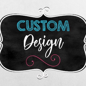 May include: A black chalkboard sign with a white frame and a decorative swirl design. The sign says "CUSTOM Design" in blue and white text.