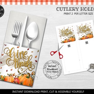 May include: Printable Thanksgiving cutlery holder with a white background and a design of pumpkins, leaves, and the words "Give Thanks".