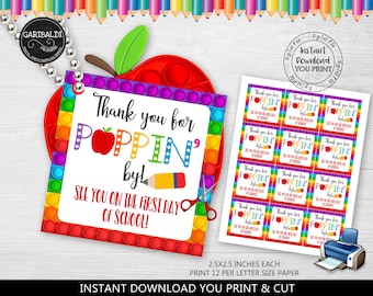 May include: A printable set of 12 colorful thank you tags featuring a rainbow pop-it toy design. The tags say "Thank you for poppin' by! See you on the first day of school!" and are 2.5 x 2.5 inches each.