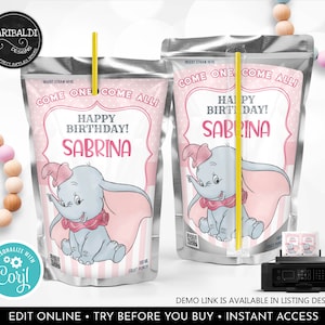 Könnte beinhalten: Eine silberne Saftbox mit einem rosa-weißen Design, das Dumbo den Elefanten zeigt. Der Text auf der Box lautet "Come one come all! Happy Birthday! Sabrina".
