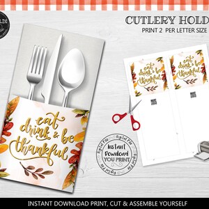 May include: Printable Thanksgiving cutlery holder with a watercolor background and fall leaves. The holder features the text "eat drink & be thankful" in gold lettering. The printable is designed to be cut and assembled.