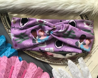 May include: Purple headband with a repeating pattern of a couple, a teacup, a diamond, and the text "Lady Whistledown" and "Simon & Daphne".