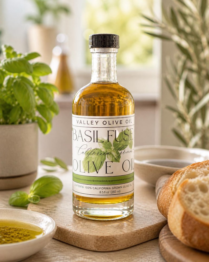 May include: A clear glass bottle of Valley Olive Oil, labeled "Basil Fuse California Grown Olive Oil." The bottle contains golden olive oil and is topped with a black cap. The label also indicates the contents are 8.5 fl oz (250 ml).
