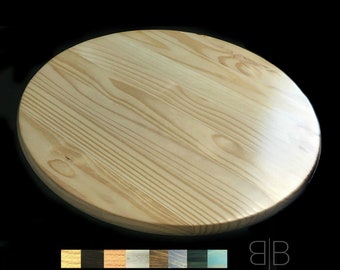 May include: A round, unfinished wooden tabletop with a natural wood grain. The tabletop is approximately 30 inches in diameter.