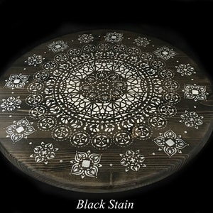 May include: A round wooden table top with a white mandala design painted on it. The table top is stained black. "Black Stain" is written in white text below the table top.