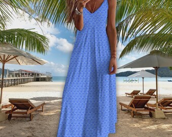 May include: A light blue maxi dress with a V-neck and spaghetti straps. The dress features a repeating white geometric pattern. The background shows a beach scene with palm trees, umbrellas, and lounge chairs.