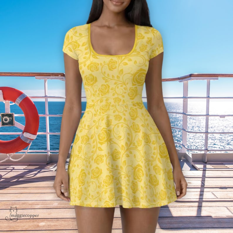 May include: A yellow dress with a rose pattern. The dress has a scoop neckline and short sleeves. The background shows a blue sky and ocean, with a red life preserver on the left. The dress is knee-length.