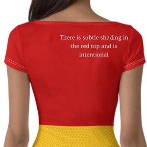 May include: A red short-sleeved top with the text "There is subtle shading in the red top and is intentional". The bottom portion of the top is yellow with a honeycomb pattern.