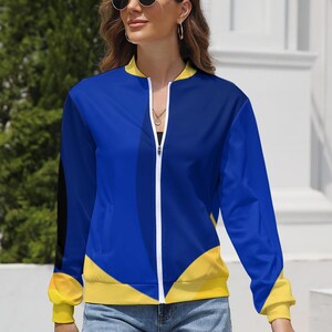 May include: A blue and yellow bomber jacket with a white zipper. The jacket features a color block design with blue and yellow panels. The cuffs and collar are yellow, and a black stripe runs down the left sleeve.