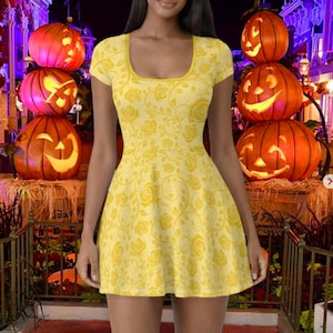 May include: A yellow dress with a rose pattern. The dress has a scoop neckline and short sleeves. The background features carved pumpkins and a Halloween theme.
