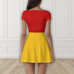 May include: A red short-sleeved dress with a yellow skirt. The top is solid red, and the skirt is yellow with a dotted pattern. The dress is fitted at the top and flares out at the waist.