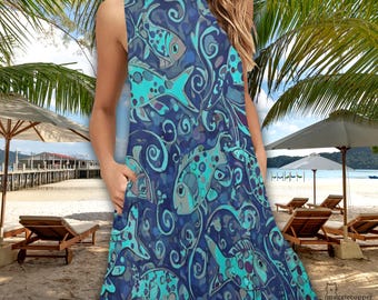 May include: Sleeveless blue dress with a fish pattern in shades of teal and blue. The dress features a round neckline and pockets. The background shows a beach scene with palm trees, umbrellas, and lounge chairs.