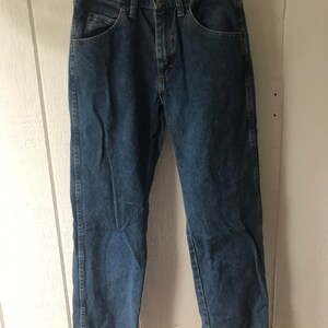 May include: A pair of blue denim jeans with a straight leg fit.
