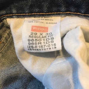 May include: A white tag with black text that reads "MADE IN MEXICO HECHO EN MEXICO 100% COTTON/ALGODON Wrangler 29 X 30 REGULAR FIT 96501DS 965R 1DS IZS-F 167-015 084084707918".