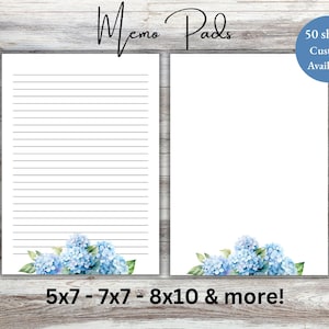 May include: Two white memo pads with blue hydrangea floral accents. One pad has lined pages, the other is blank. Text reads "Memo Pads", "50 sheets Custom Available!", and "5x7 - 7x7 - 8x10 & more!"