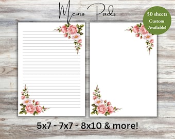 May include: White memo pads with floral corner designs. One pad has lined pages, the other is blank. The pads are decorated with pink roses and green leaves. Text reads "Memo Pads", "50 sheets Custom Available!", and "5x7 - 7x7 - 8x10 & more!"