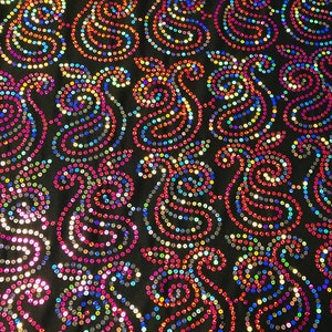 May include: Black fabric with a paisley pattern made of iridescent sequins in shades of pink, blue, green, and gold.