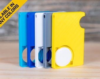 May include: Five different colored keychains with a round button on the side. The keychains are blue, teal, white, gray, and yellow.  Available in many colors.