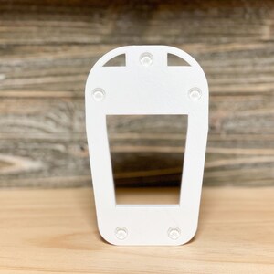May include: White plastic light fitting with a rectangular opening and four small holes on the top and bottom.