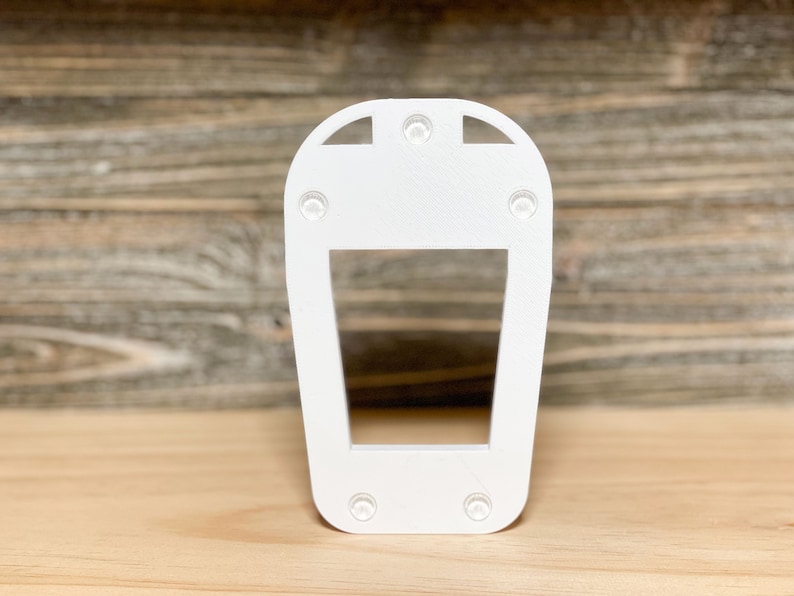 May include: White plastic light fitting with a rectangular opening and four small holes on the top and bottom.