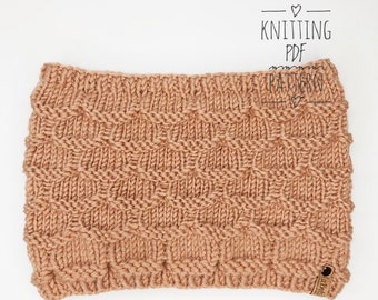 May include: A knitted headband in a light brown color with a textured pattern. The headband is made with a soft yarn and has a simple, elegant design.
