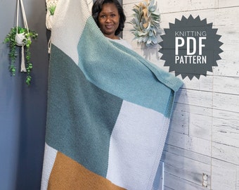 May include: A woman holds up a knitted blanket with a color block pattern in shades of white, teal, mustard yellow, and brown. The blanket is made with a simple knit stitch. The text "Knitting PDF Pattern" is visible in the image.